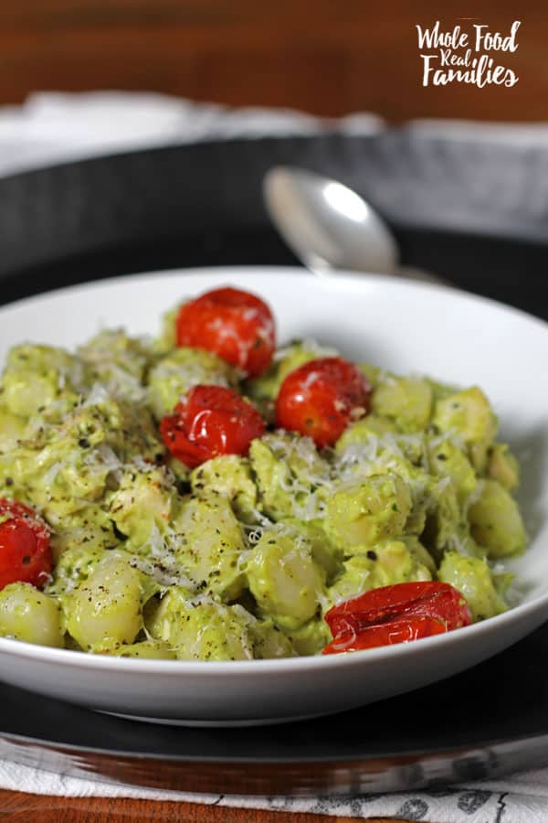 Creamy Avocado Pesto Gnocchi with Roasted Tomatoes is delicious and crazy fast. Perfect for when you are pressed for time but still want to get a real, nourishing meal on the table for your family.