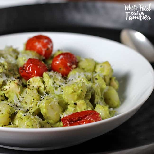 Creamy Avocado Pesto Gnocchi with Roasted Tomatoes is delicious and crazy fast. Perfect for when you are pressed for time but still want to get a real, nourishing meal on the table for your family.