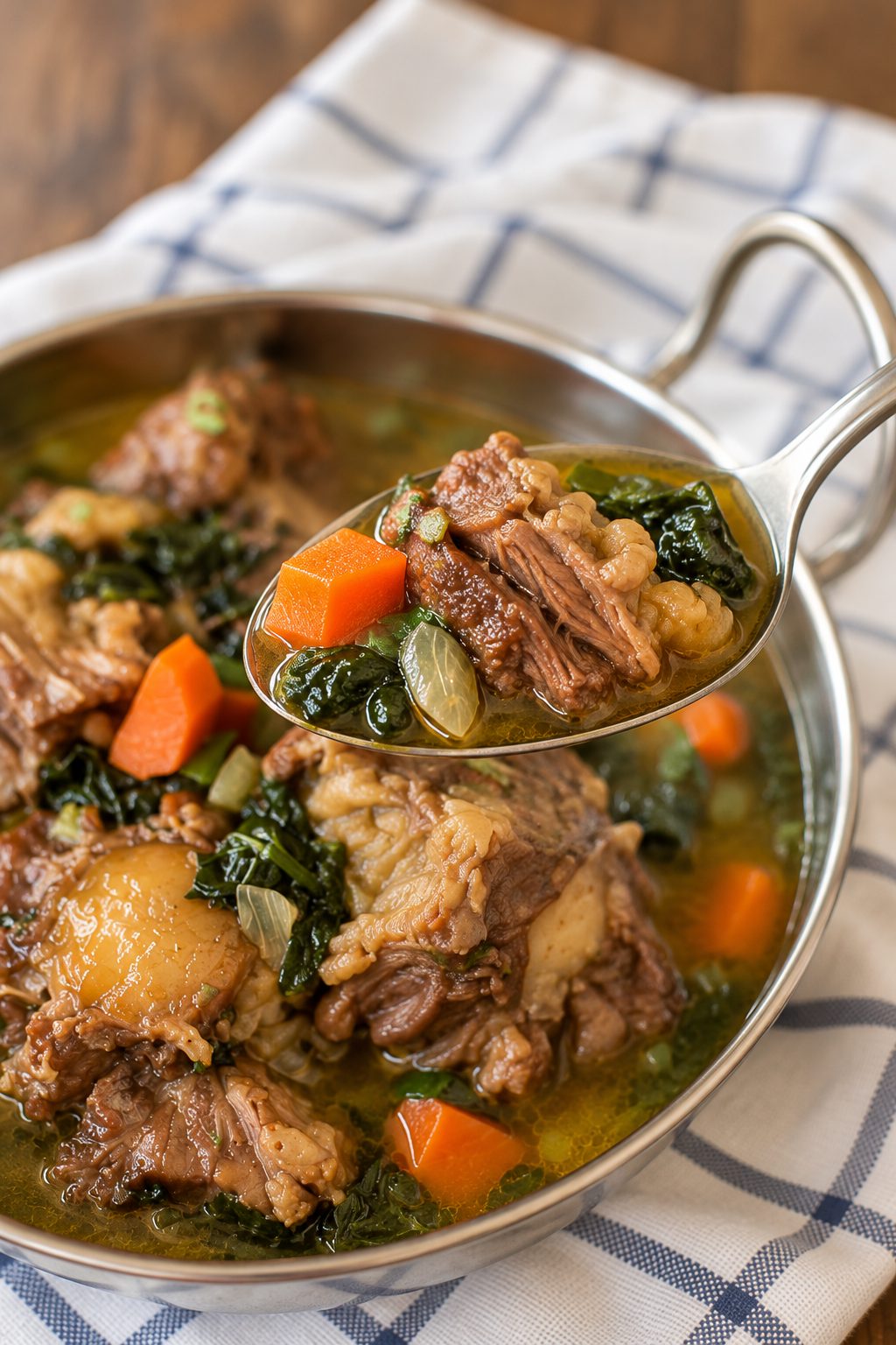 Beef oxtail soup in a dish with kale,  and carrots