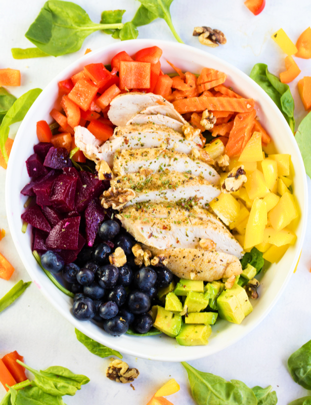 Rainbow chicken salad ingredients in a bowl