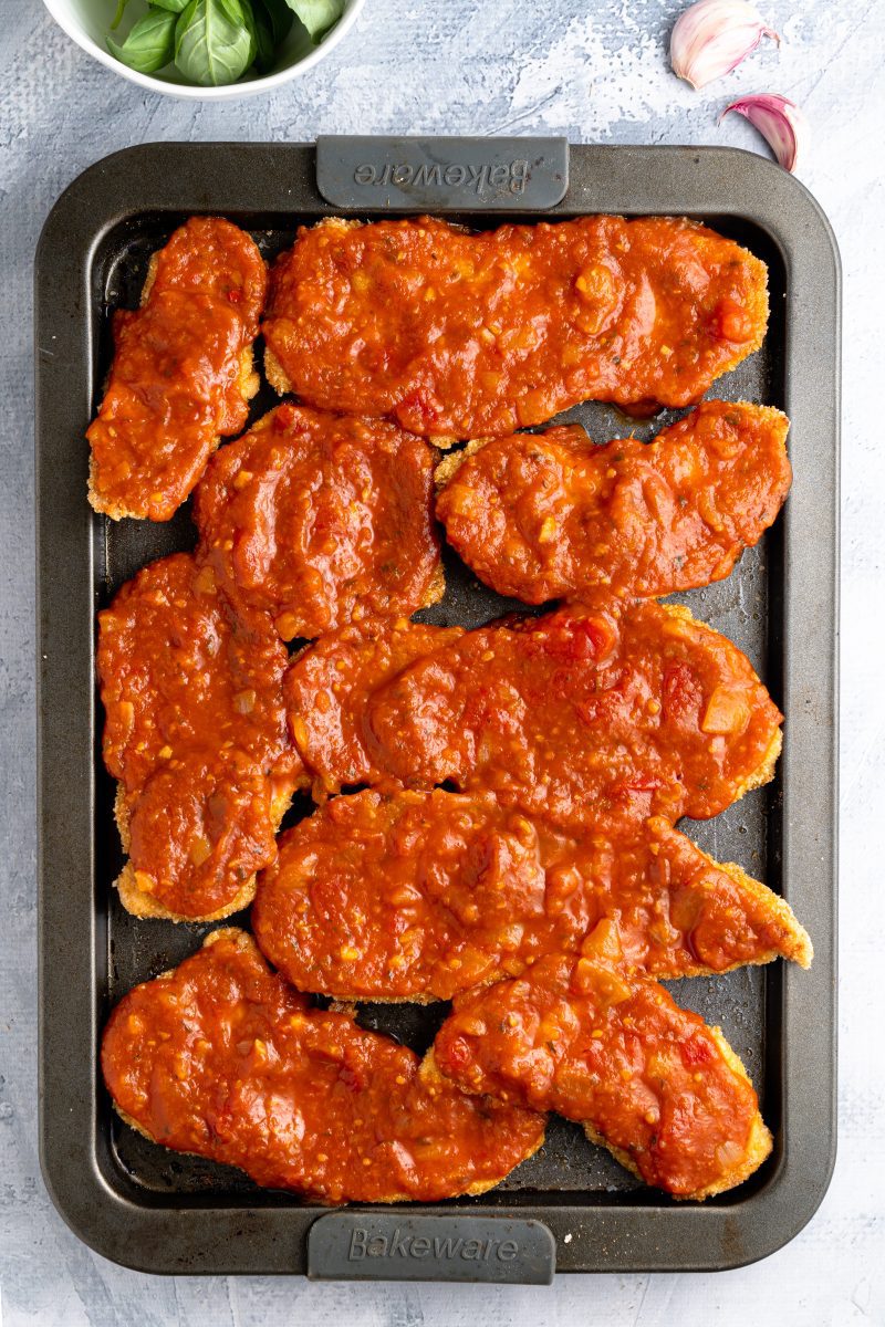 gluten-free chicken parmesan being prepared 
