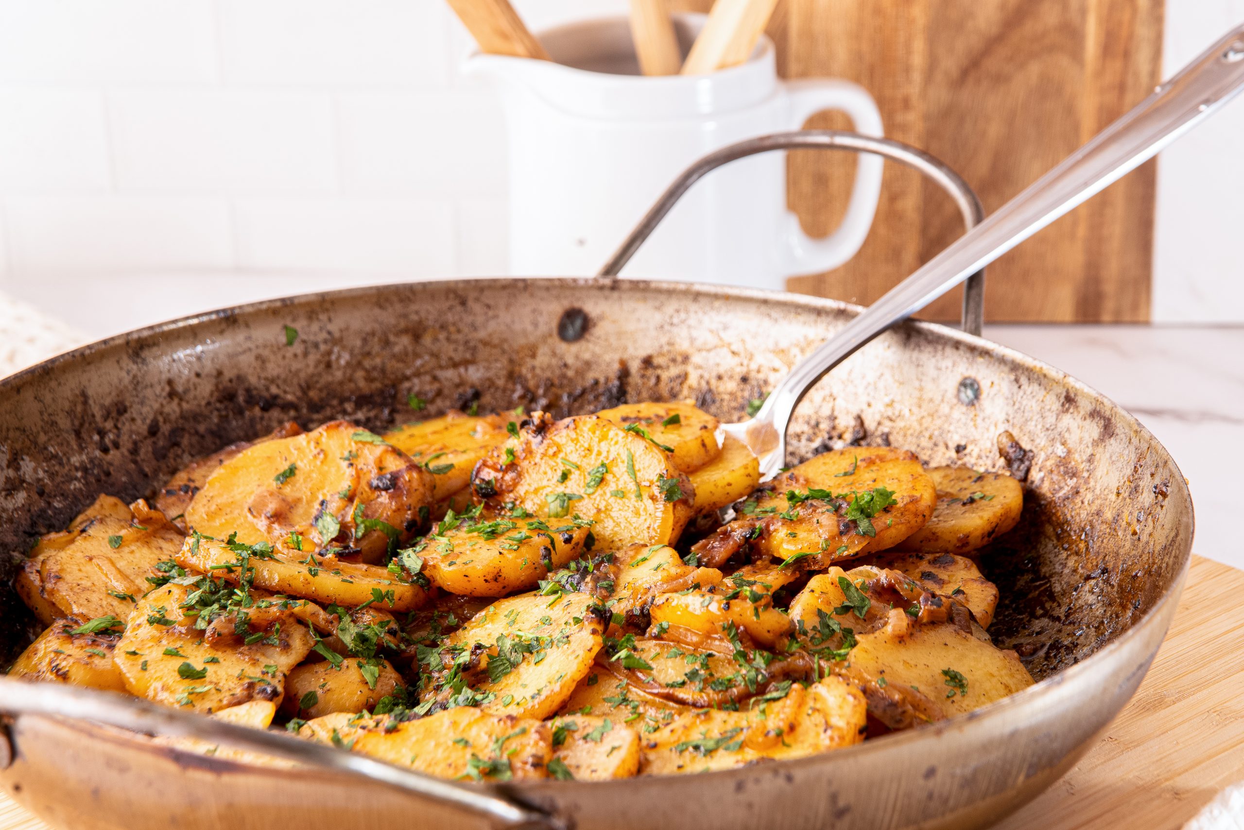 Cooking Smothered Potatoes in a cast iron skillet
