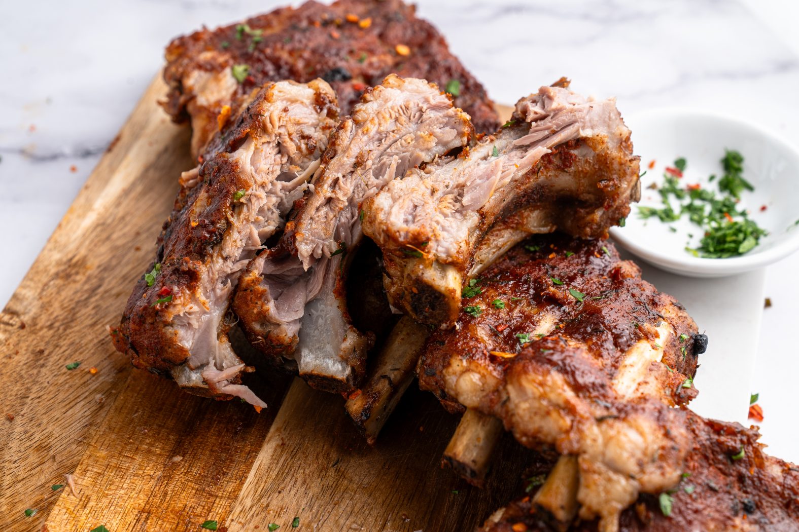 Instant pot baby back ribs cut up on a chopping board