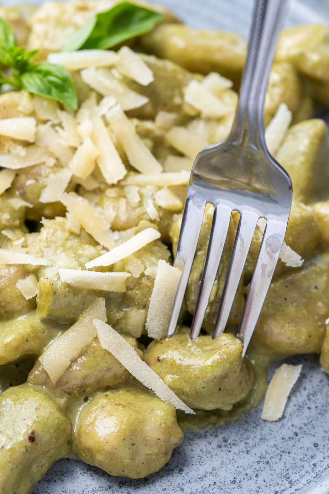 Fork sticking into some potato gnocchi