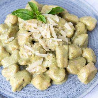 Overhead of potato gnocchi served on a blue plate