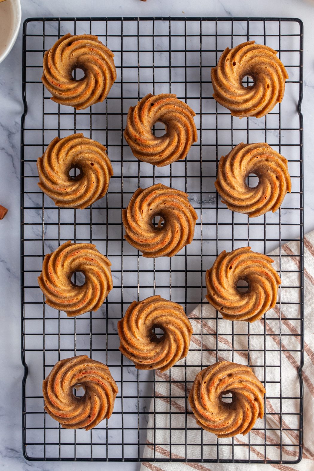 Top down of unglazed pumpkin bundt cakes on a cooling rack