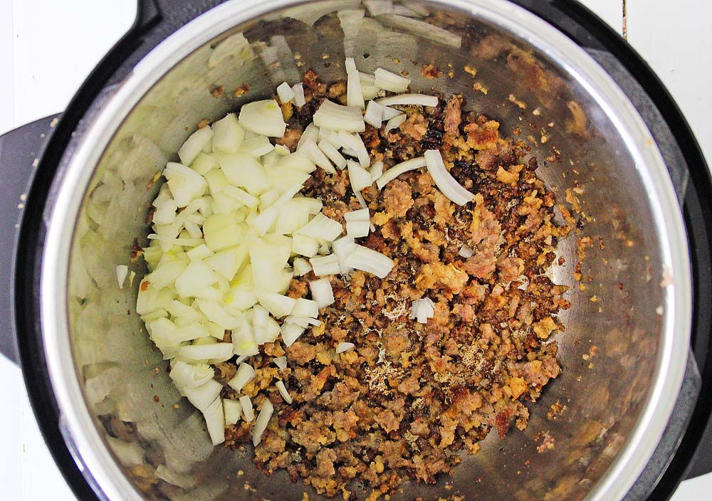 browning onions and sausage in an Instant Pot for ravioli soup