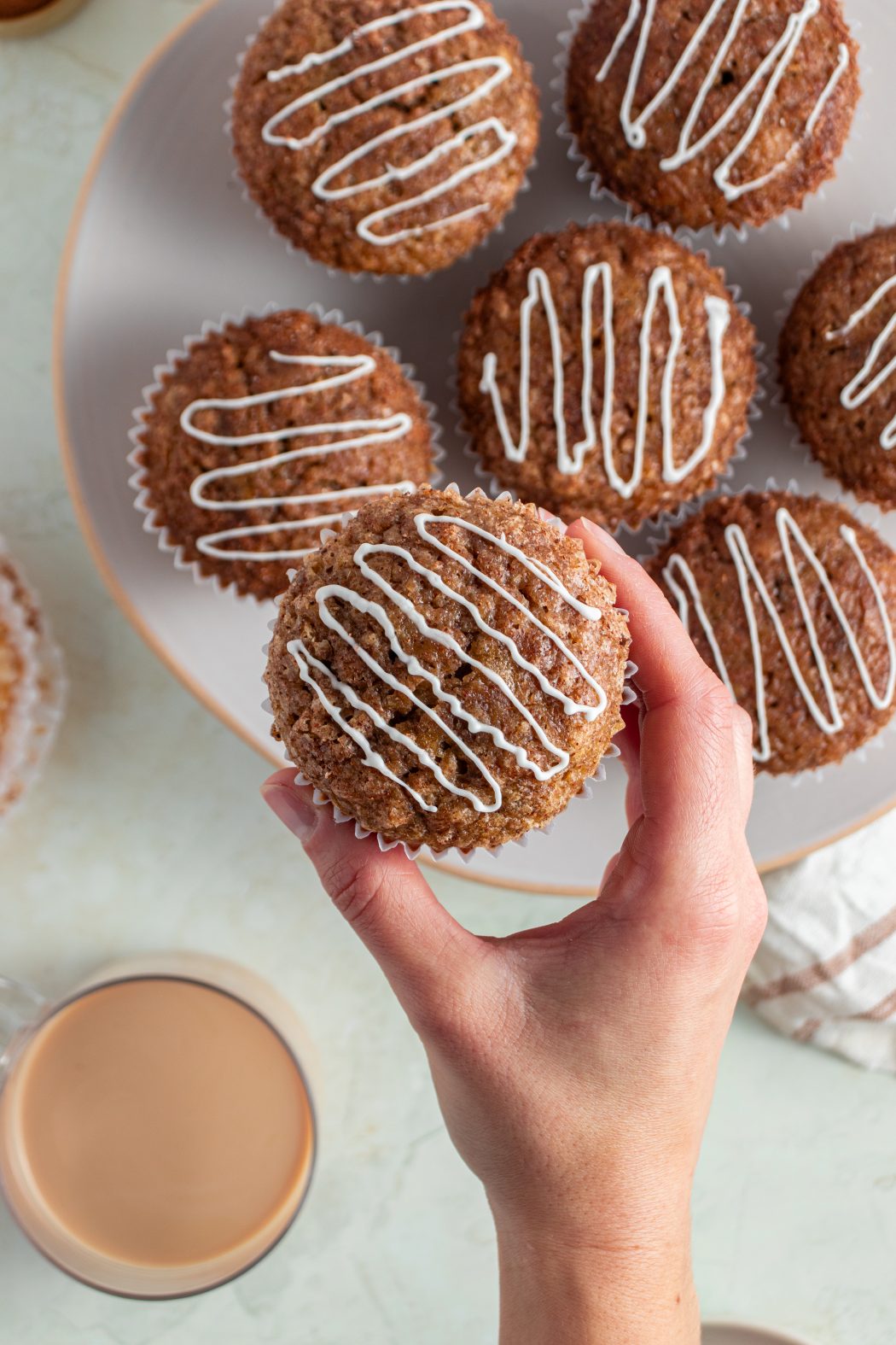 a person holding a pumpkin banana muffin