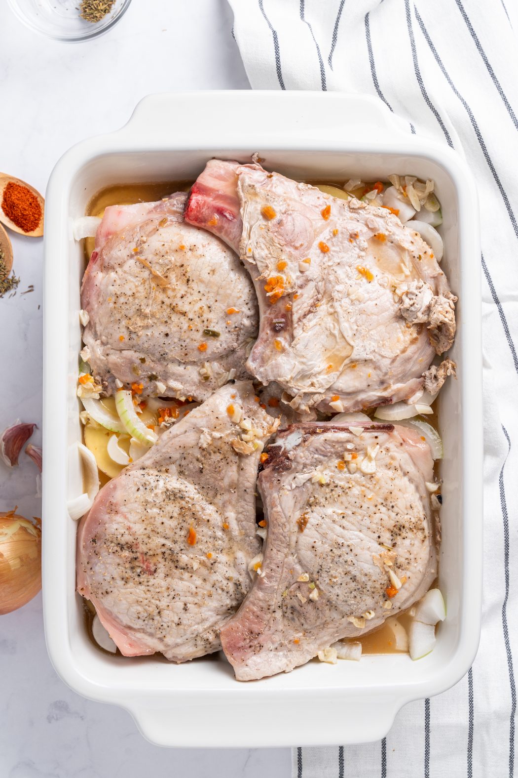 seasonings on pork chops and potatoes