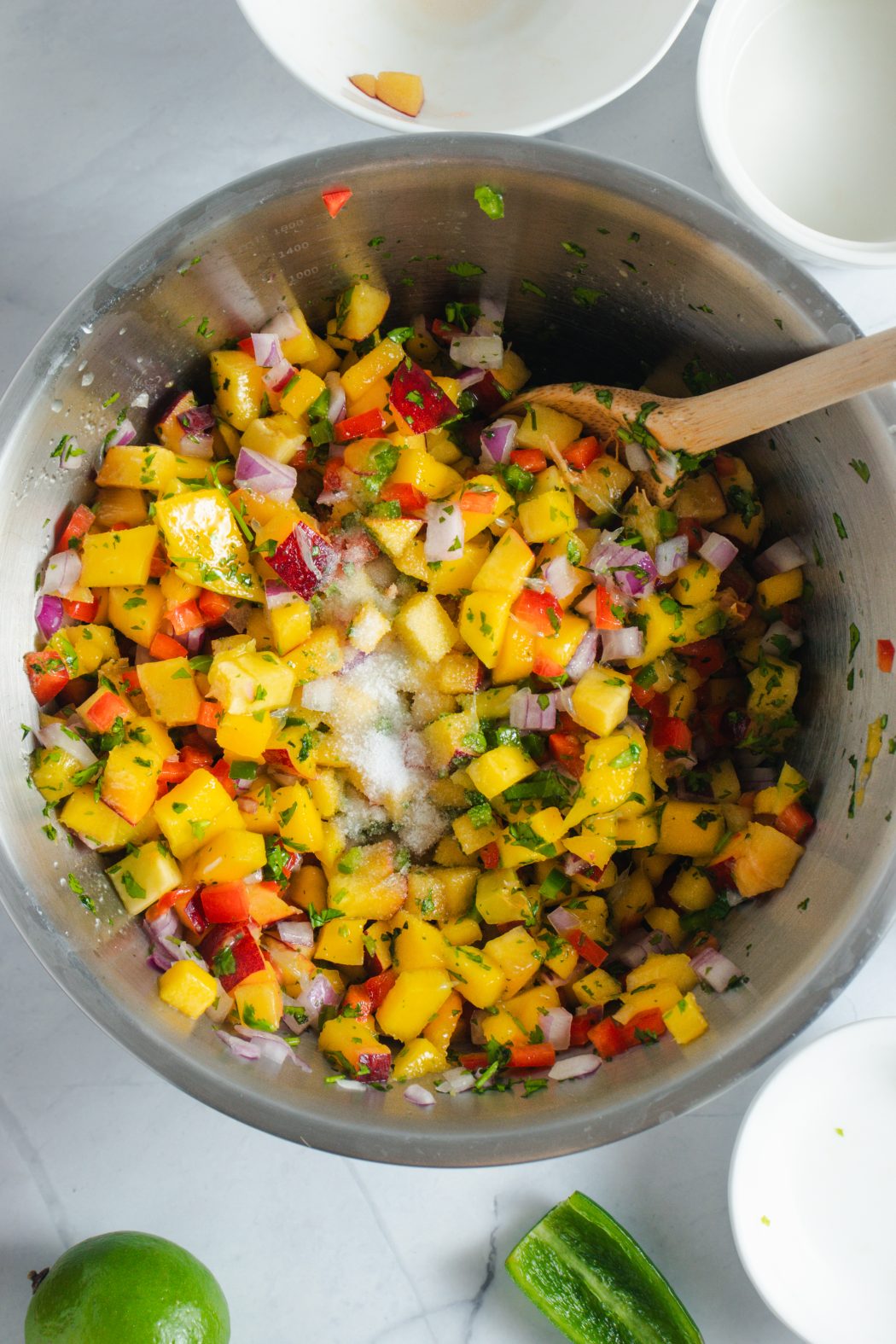 peach and mango salsa in a mixing bowl