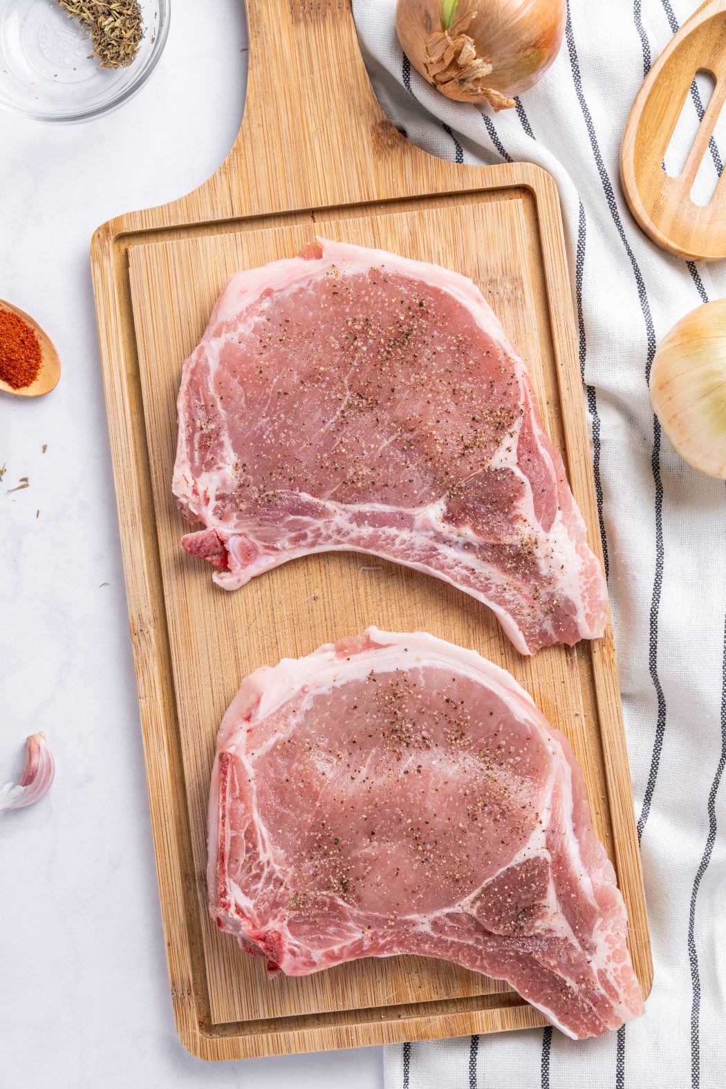 pork chop cuts of meat on a butcher block