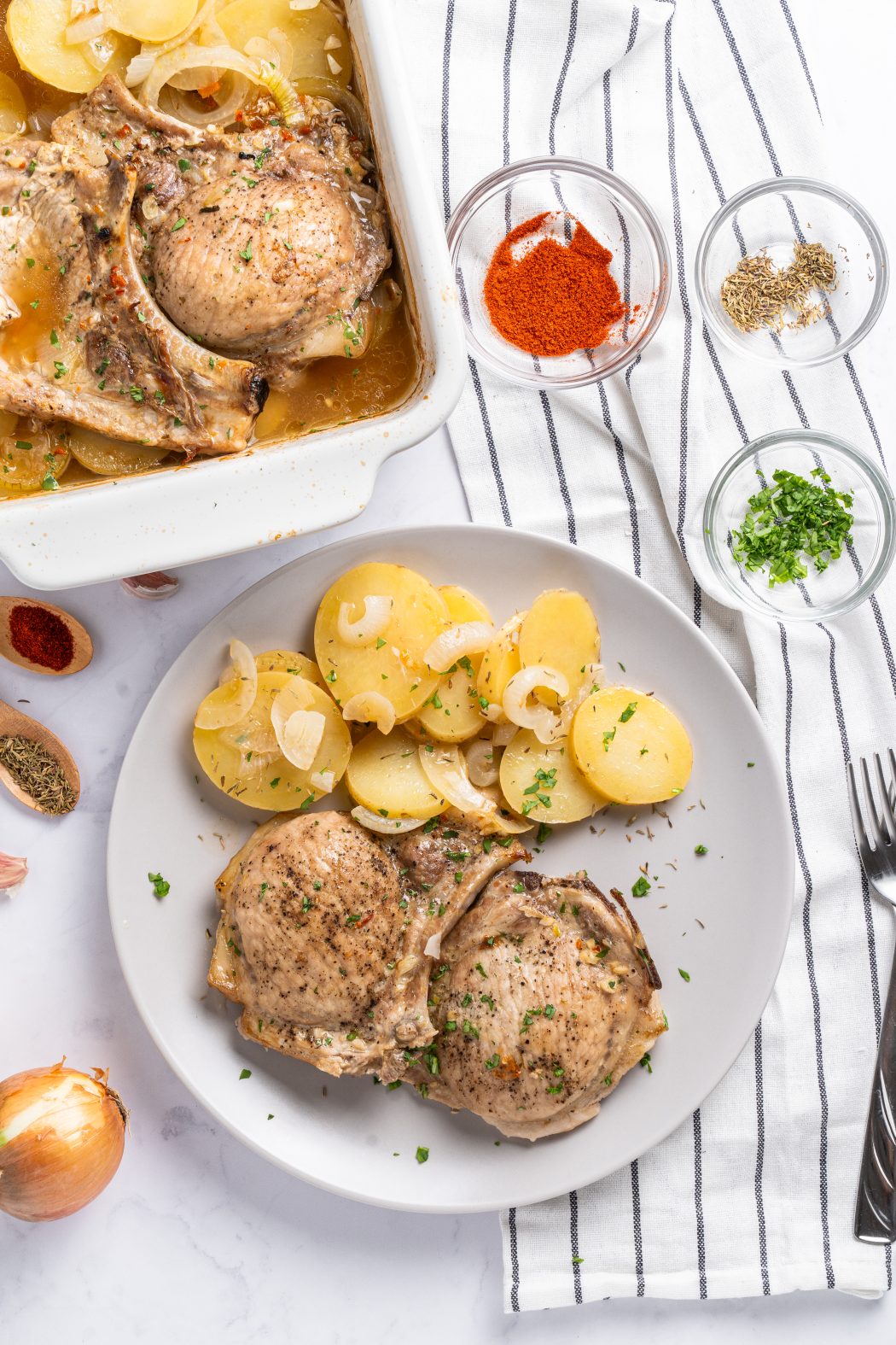 baked pork chops and potatoes on a plate