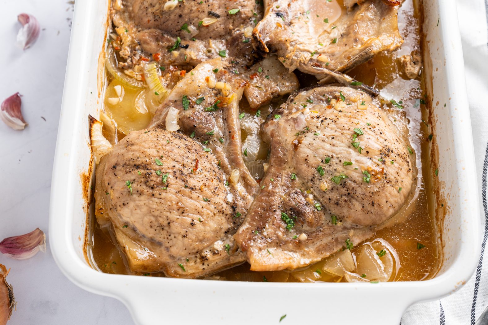baked pork chops and potatoes in a baking dish