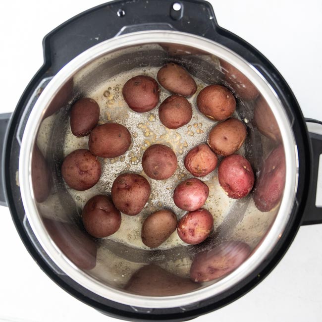 baby potatoes coated with garlic and butter in an Instant Pot