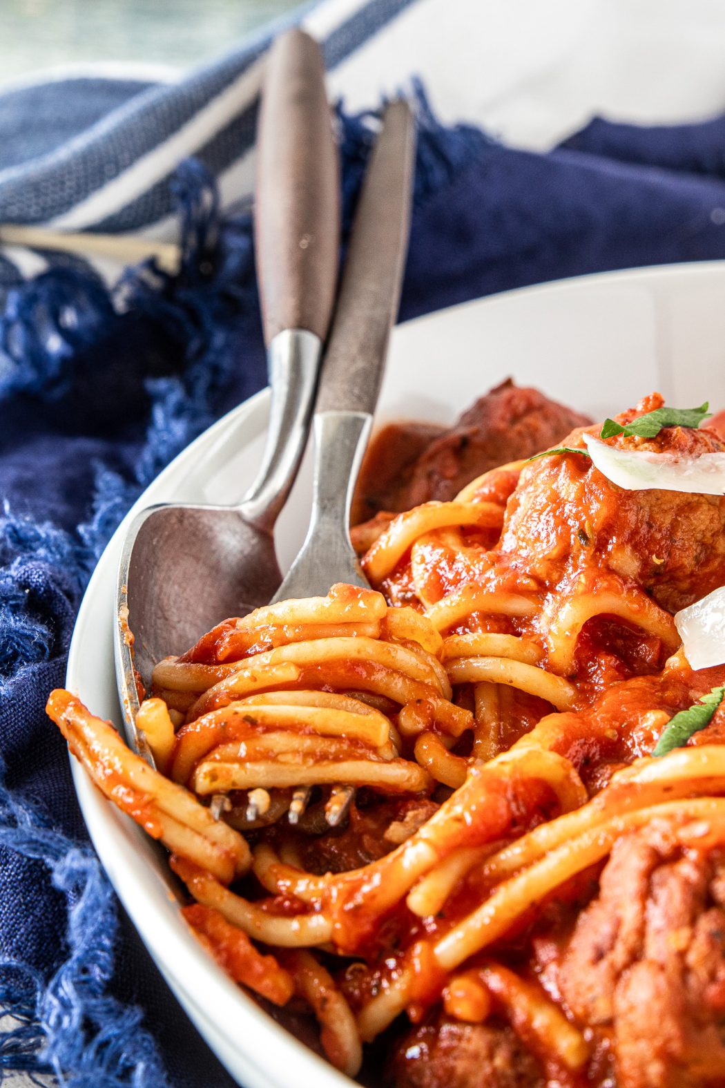 A fork with spaghetti noodles wrapped around it