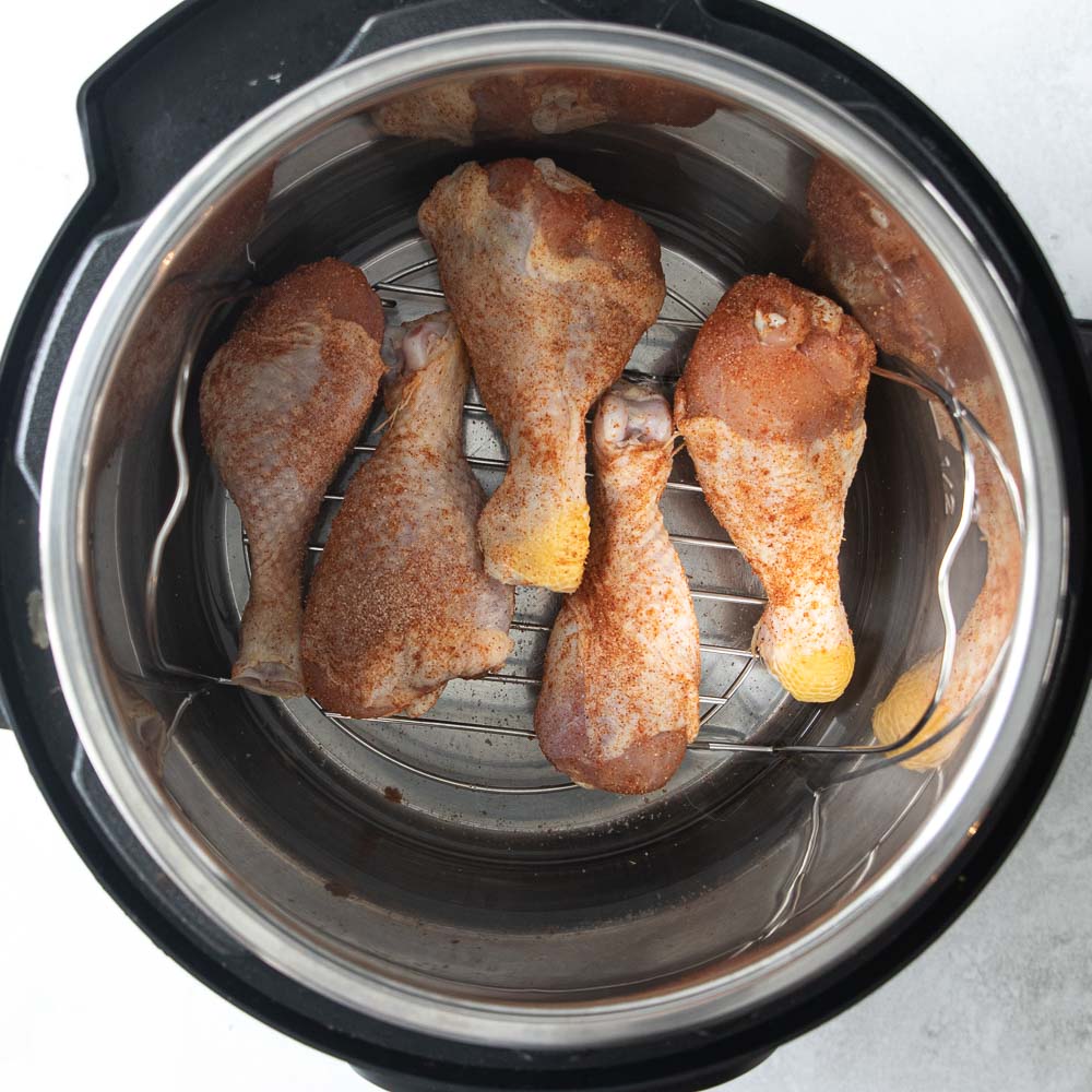 chicken legs on a trivet in an instant pot