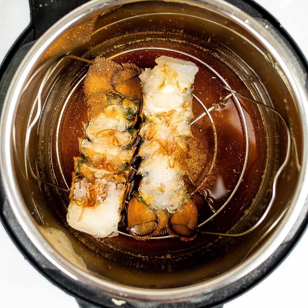 lobster tails on a trivet in an Instant Pot