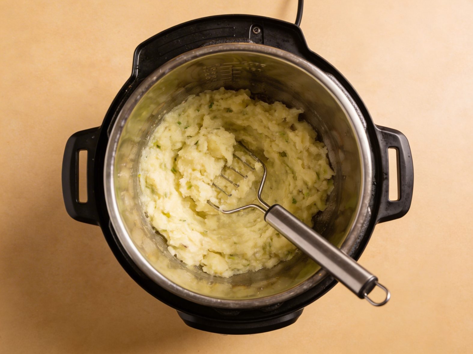 Using a potato masher in an Instant Pot for Colcannon