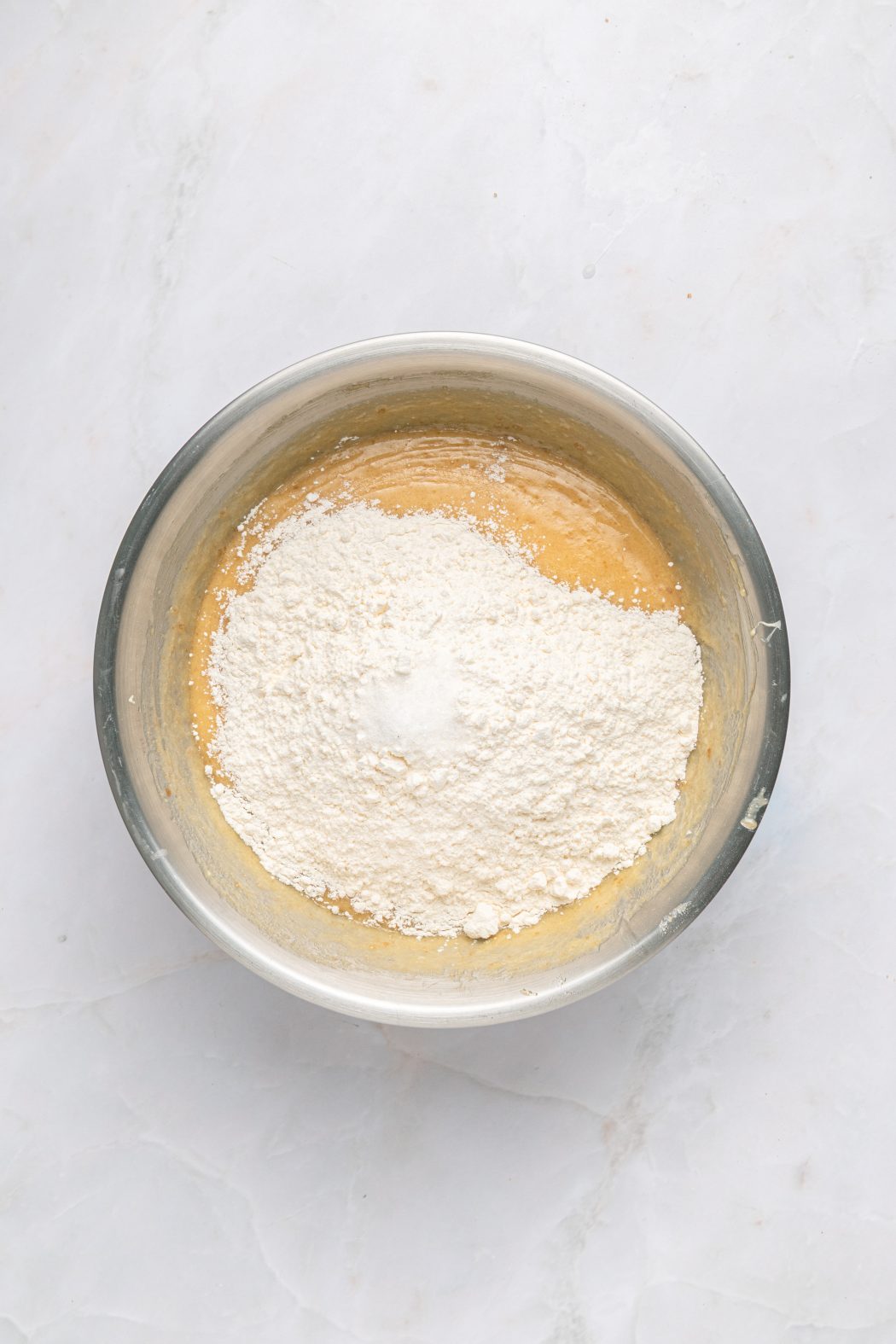 folding in flour in a white chocolate brownie mix
